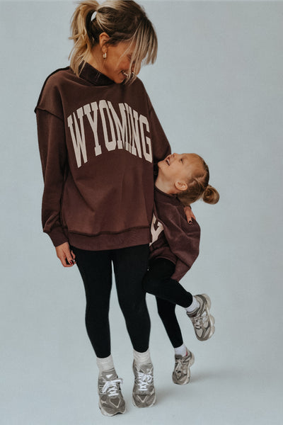 Matching mama and mini reversible Wyo mock neck sweatshirts in brown with WYOMING and WY designs