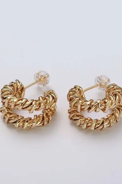 These exquisite earrings feature a unique design that creates the illusion of wearing two separate earrings. Crafted with radiant gold, they add a touch of sophistication to any ensemble.