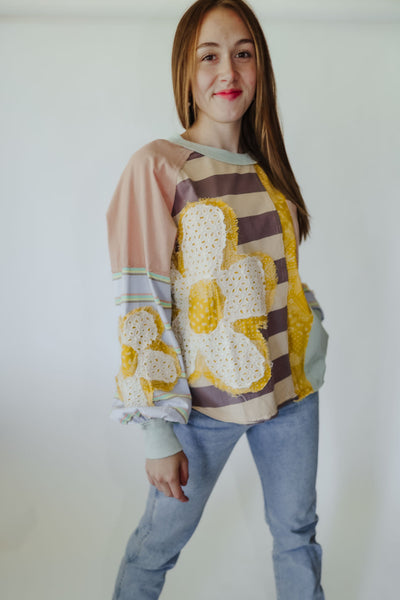 Super fun patchwork top featuring all the fun details Oversized fit Dolman sleeve Functional pockets  Ribbed cuffs Raw hem  Patch on the back with smile detail
