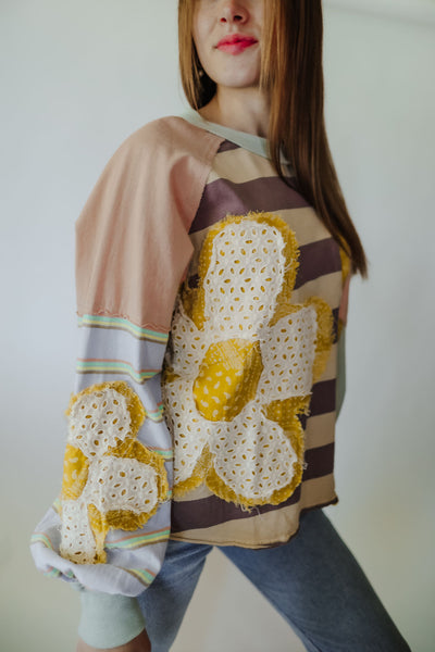 Super fun patchwork top featuring all the fun details Oversized fit Dolman sleeve Functional pockets  Ribbed cuffs Raw hem  Patch on the back with smile detail