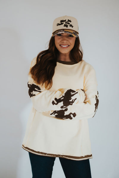 women's oversized butter yellow Powder Horn pullover sweater with brown Wyoming bucking horse sleeve detailing and the perfectly worn in feel 