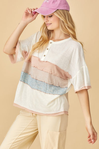 This cutie is super soft, features multi-colored wide ruffled stripes in pastel hues, a wide scoop neckline, short sleeves with pink edging + non-functional button down detail. With a perfectly loose fit, style it with your fav cargos or jeans + sneakers for an effortlessly casual yet cool vibe.