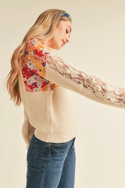 Mixed media knit top Crew neckline Ribbed knit bodice Woven floral print contrast at shoulders See-through lace insert on sleeves Ribbed hem