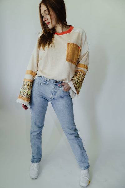 This cute + comfy long sleeve top has wide sleeves with mixed pattern prints, raw edge detailing + a mineral wash patch chest pocket.