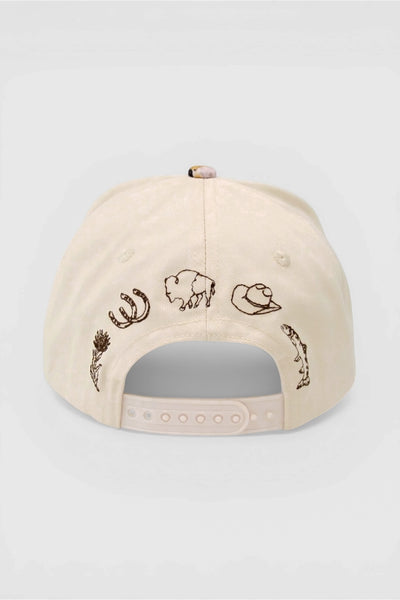 Beige cap with embroidered Wyoming designs including Indian paintbrush, horseshoe, bison, cowboy hat and trout. 
