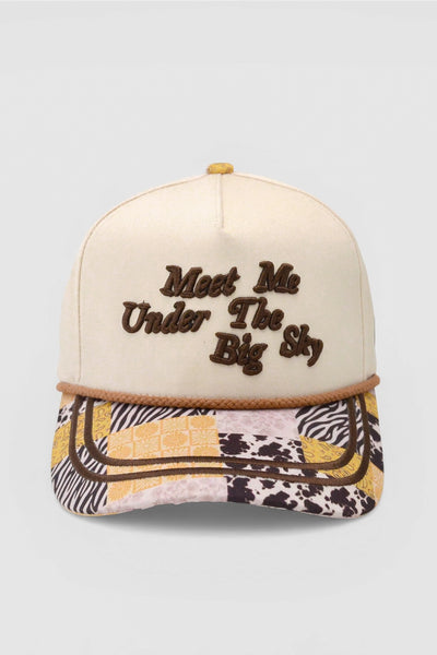 Cap with 'Meet Me Under The Big Sky' text on a plain background
