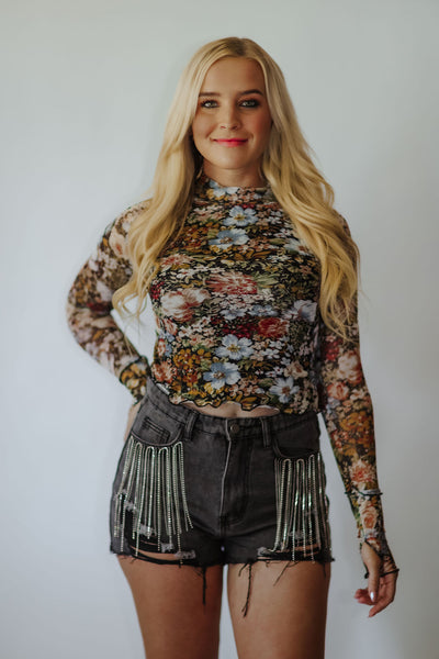 Dreamy floral print mesh top. Soft + comfy Semi sheer material. Super stretchy. High neckline — so cute peeking out from underneath your tops. Exposed seams. Long sleeves. THUMB HOLES!