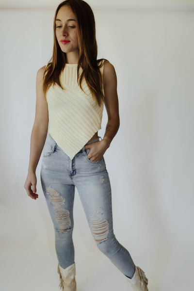 Ivory sweater tank ribbed to perfection with a scarf hem + crafted from a lightweight knit fabric, this stretchy top has a rounded neckline and a v bottom hem. Enjoy all-day comfort while looking stylish + chic.