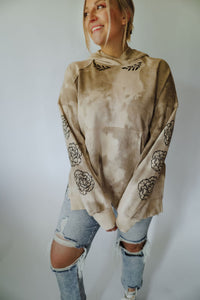 Oat tie dye hoodie with floral details on the sleeves + along neckline. Graphic designed + stamped locally in Casper, WY by the amazing Burgundy Blooms.  Oversized fit.