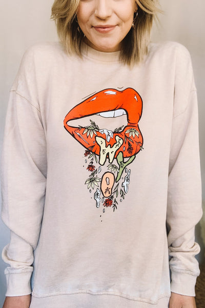 open mouth graphic featuring “WYO” lettering + Indian paintbrush wildflowers “dripping” out. burnout crewneck