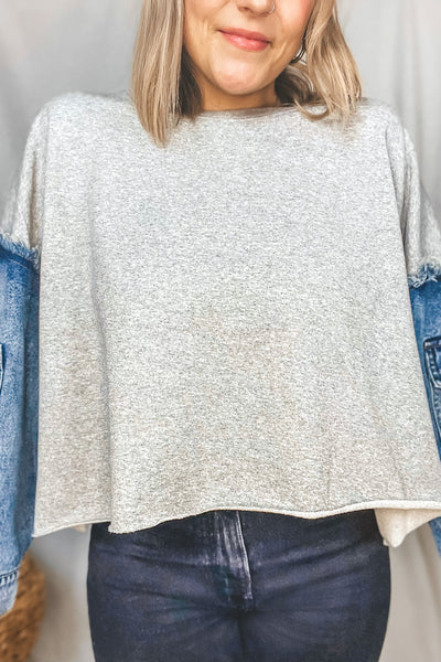This oversized cutoff crewneck is so unique with its contrast denim pocket sleeves. It features a ribbed crewneck + distressed details, like the exposed frayed hem at the shoulders and raw edge cut cropped hem