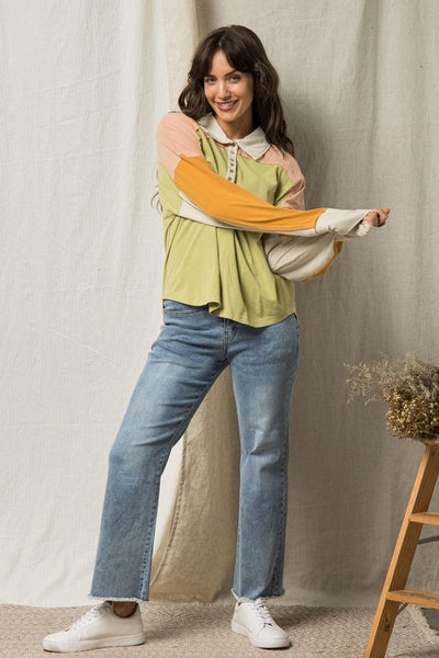 The coolest polo shirt that has us feelin’ inspired by 90s fashion! From the oversized fit to the amazing color-blocking, we're digging it. Half buttons up the front with a collared neckline. Drop shoulder with long sleeves. Colors are avocado green, mustard yellow, pretty peach + beige.