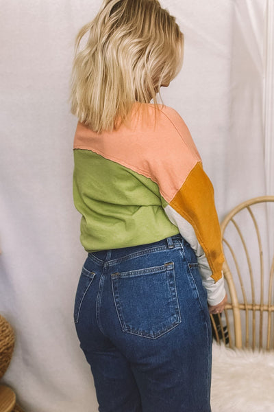 The coolest polo shirt that has us feelin’ inspired by 90s fashion! From the oversized fit to the amazing color-blocking, we're digging it. Half buttons up the front with a collared neckline. Drop shoulder with long sleeves. Colors are avocado green, mustard yellow, pretty peach + beige.