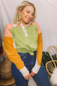 The coolest polo shirt that has us feelin’ inspired by 90s fashion! From the oversized fit to the amazing color-blocking, we're digging it. Half buttons up the front with a collared neckline. Drop shoulder with long sleeves. Colors are avocado green, mustard yellow, pretty peach + beige.