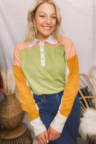 The coolest polo shirt that has us feelin’ inspired by 90s fashion! From the oversized fit to the amazing color-blocking, we're digging it. Half buttons up the front with a collared neckline. Drop shoulder with long sleeves. Colors are avocado green, mustard yellow, pretty peach + beige.